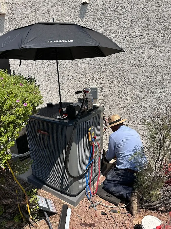 HVAC technician performing outdoor AC maintenance in Three Rivers